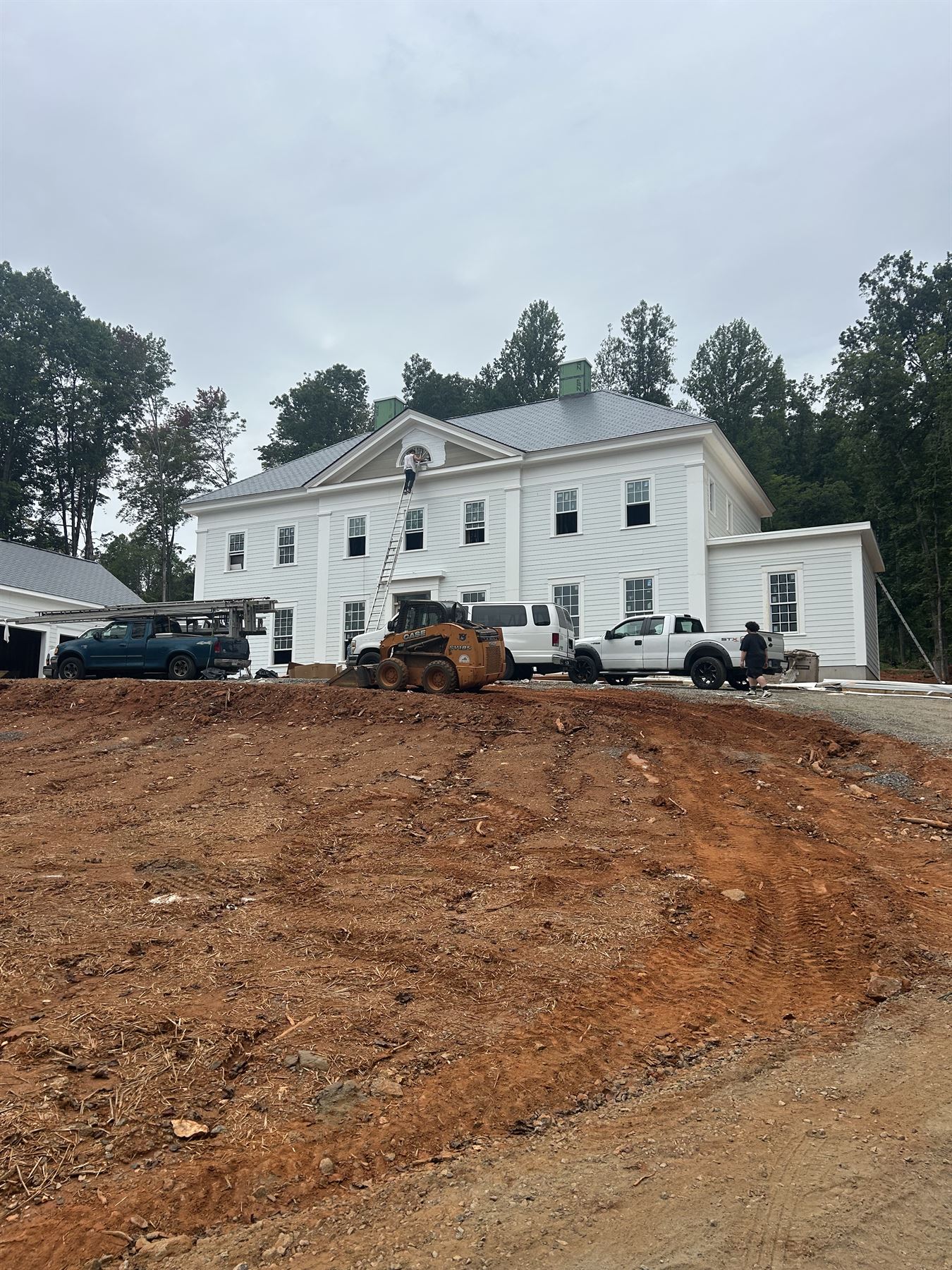 Two-story white estate home nearing completion