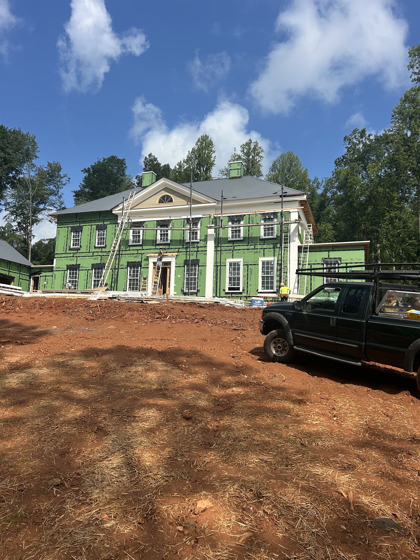 Estate home under construction with exterior sheathing